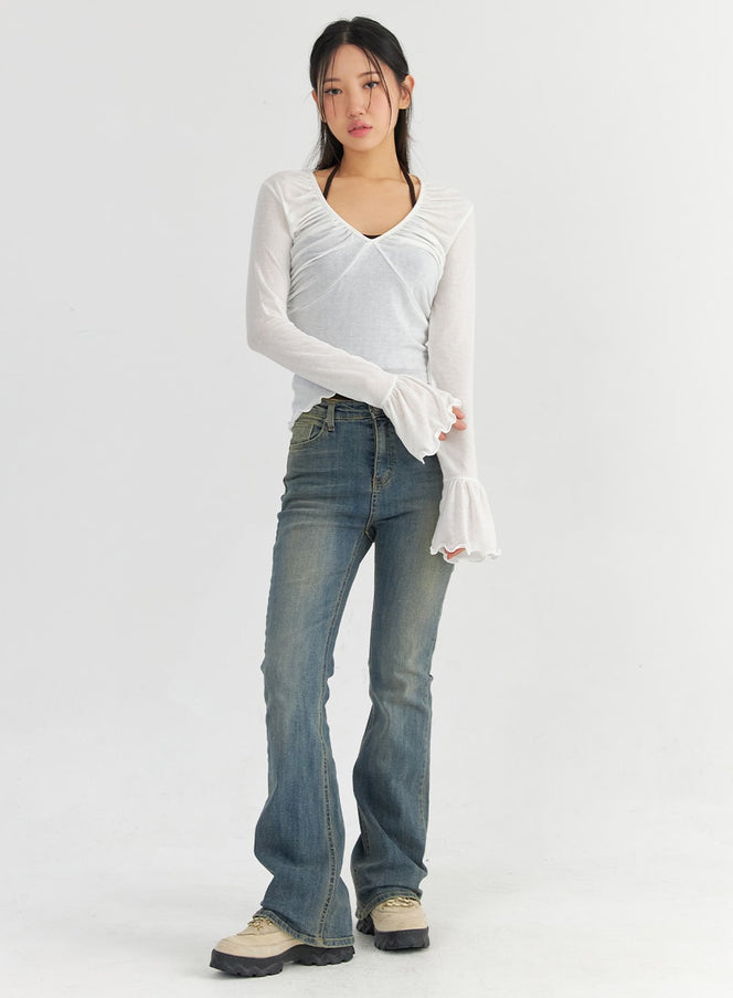 LEWKIN Slim Washed Bootcut Jeans CO327 in dark blue, full-body front view on model, slim fit with vintage wash, bootcut hem, paired with white sheer top and chunky boots.