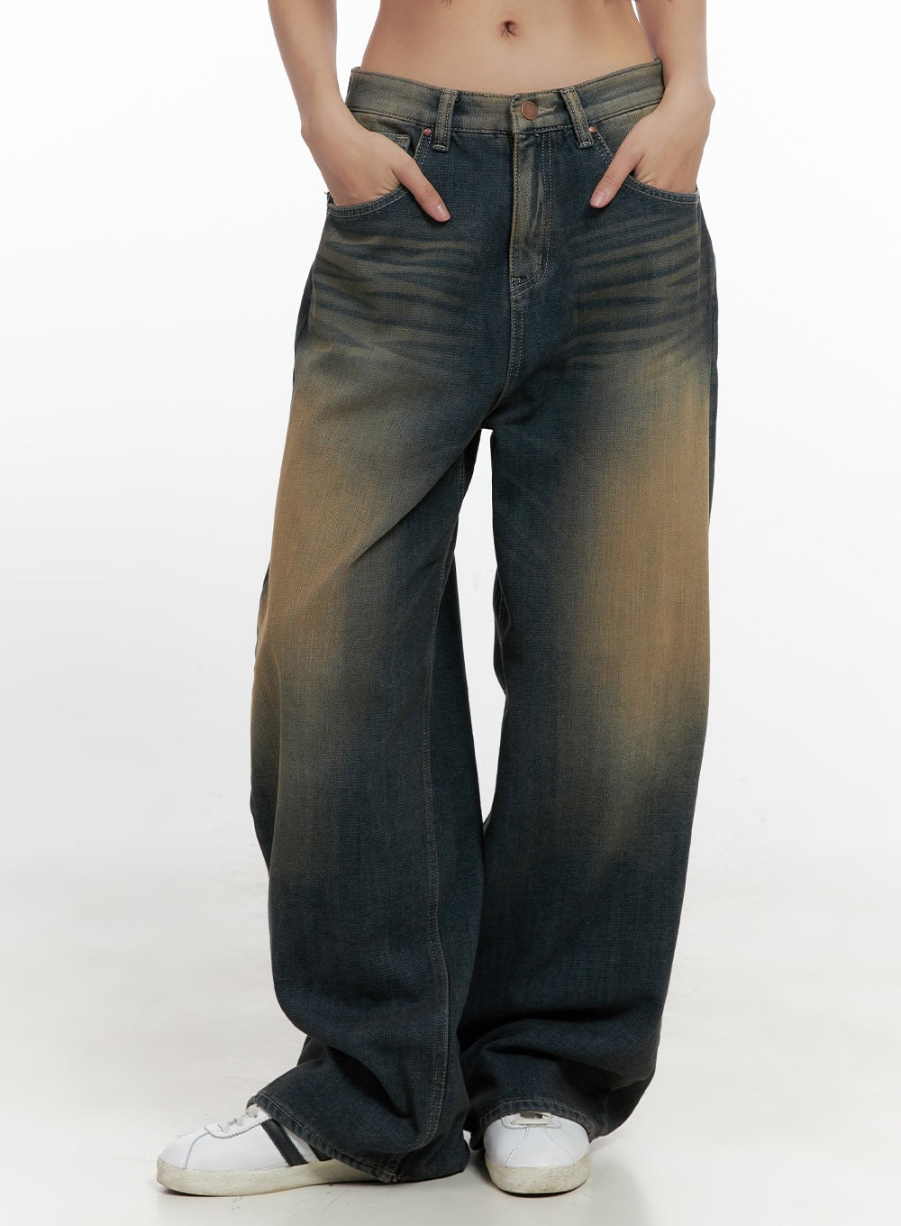 LEWKIN Bryana Cotton Comfort Wide Leg Jeans CN419 in dark blue, front crop view on model, hands in pockets, vintage washed cotton denim with amber tint, low-rise wide leg silhouette, styled with white sneakers.