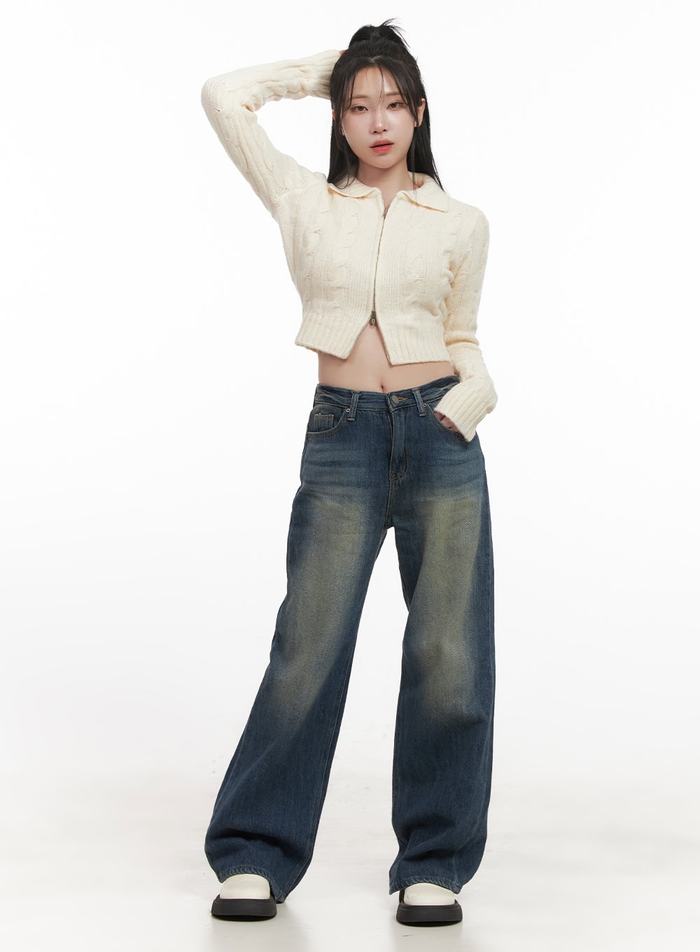 Audrey Washed Wide-Leg Jeans CJ516 in dark blue, full-body front shot on model, wide-fit washed denim with vintage fading, styled with cream zip-up cropped cable-knit cardigan and white loafers.