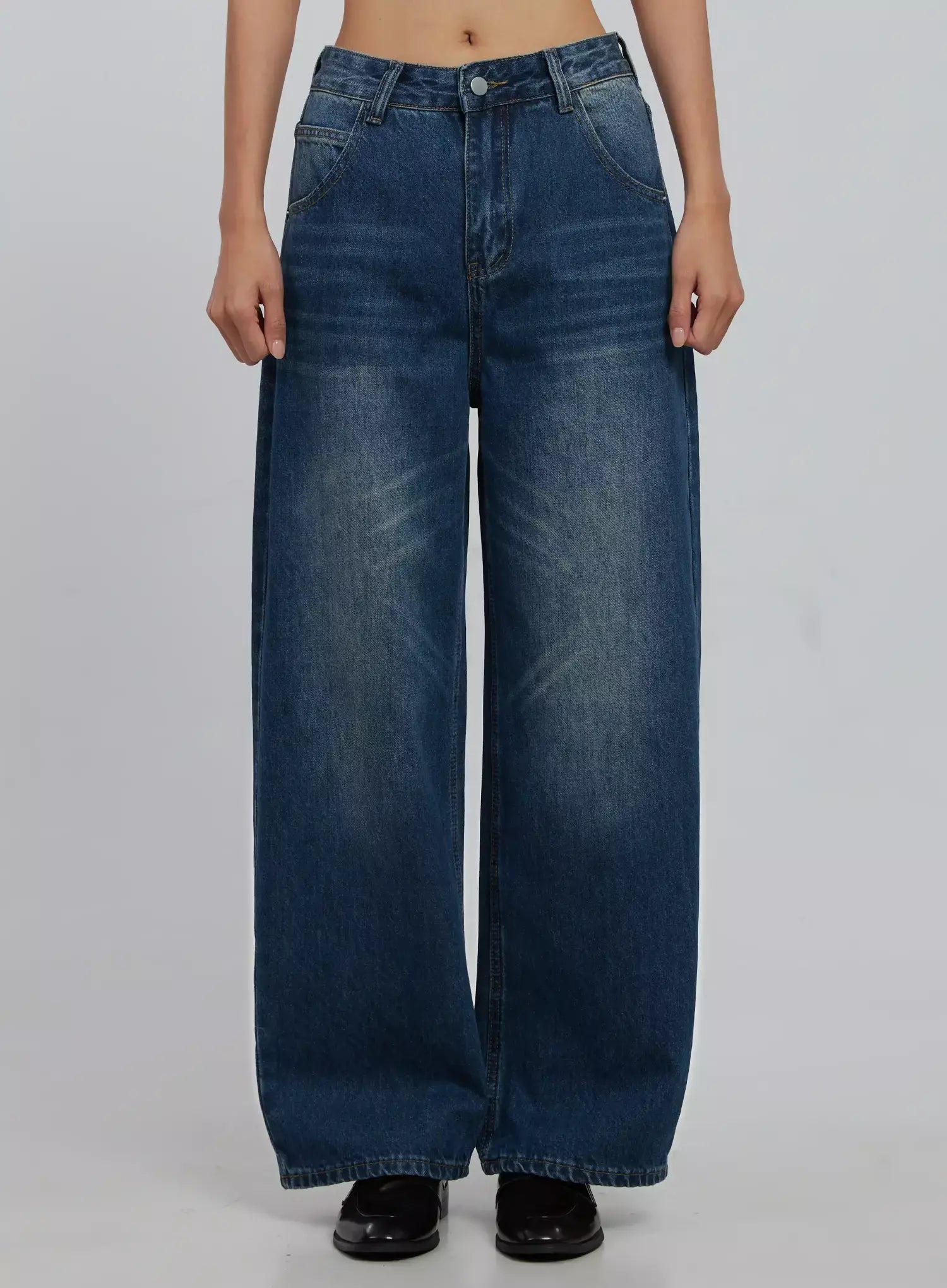 LEWKIN Alaina Wide Leg Jeans IJ508 in dark blue, front crop view on model, wide-fit cotton denim with washed fading, belt loops, front pockets, paired with black loafers.