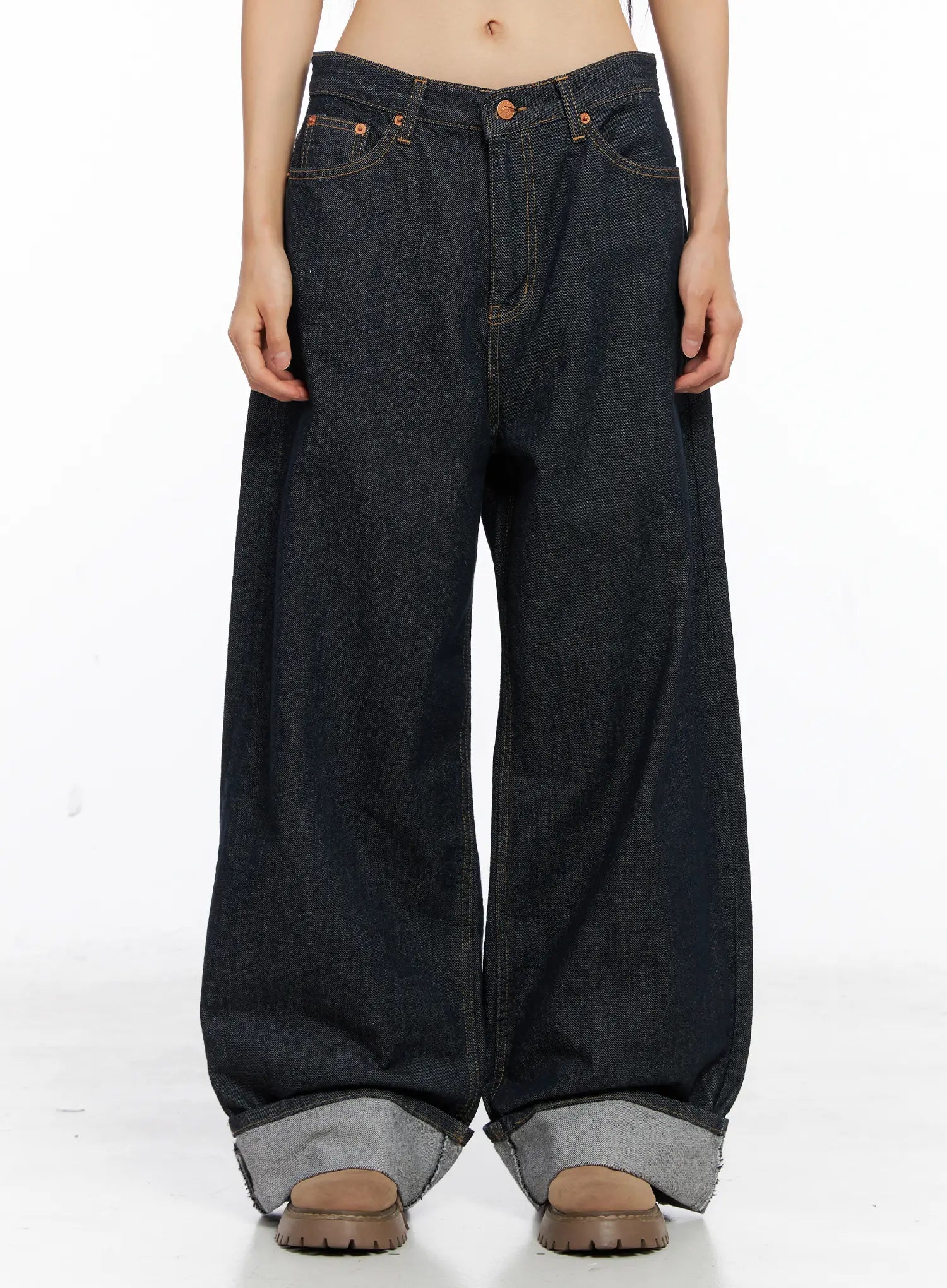 LEWKIN Oakley Cuffed Wide-Leg Jeans CS511 in dark blue, front mid-shot on model, loose-fit cotton baggy silhouette with rolled cuffs exposing grey contrast hem, copper rivets.