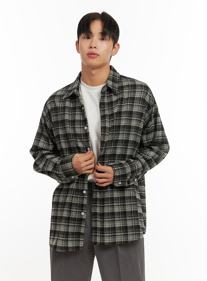 LEWKIN Men's Checkered Flannel ID406 in dark green, front close-up on model buttoning shirt, oversized flannel with spread collar, layered over white tee with grey trousers.