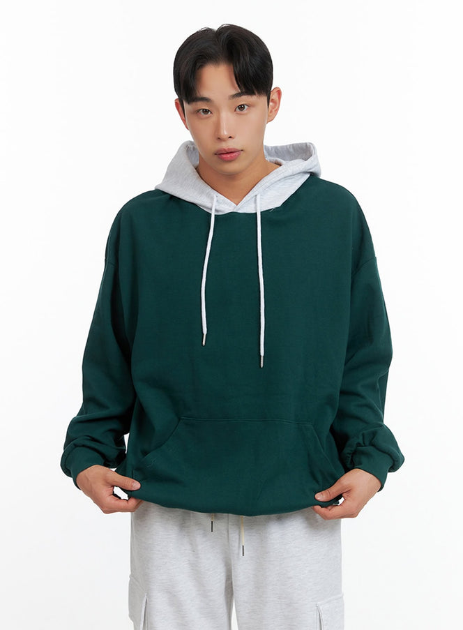 LEWKIN Men's Contrasting Hoodie (Green) IU414 in green, front crop shot on model, oversized fleece body with contrast light grey hood and white drawstring, hands in kangaroo pocket, paired with grey cargo pants.