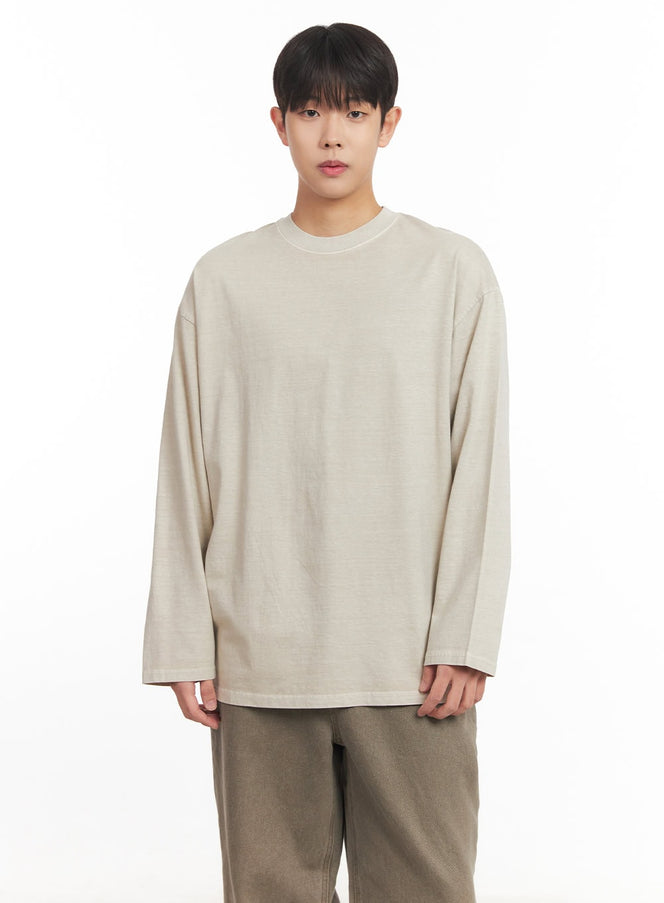 LEWKIN Men's Washed Long-Sleeve T-Shirt IM527 in light beige, front upper-body shot on model, oversized drop-shoulder fit with washed cotton fabric, paired with khaki wide-leg trousers.