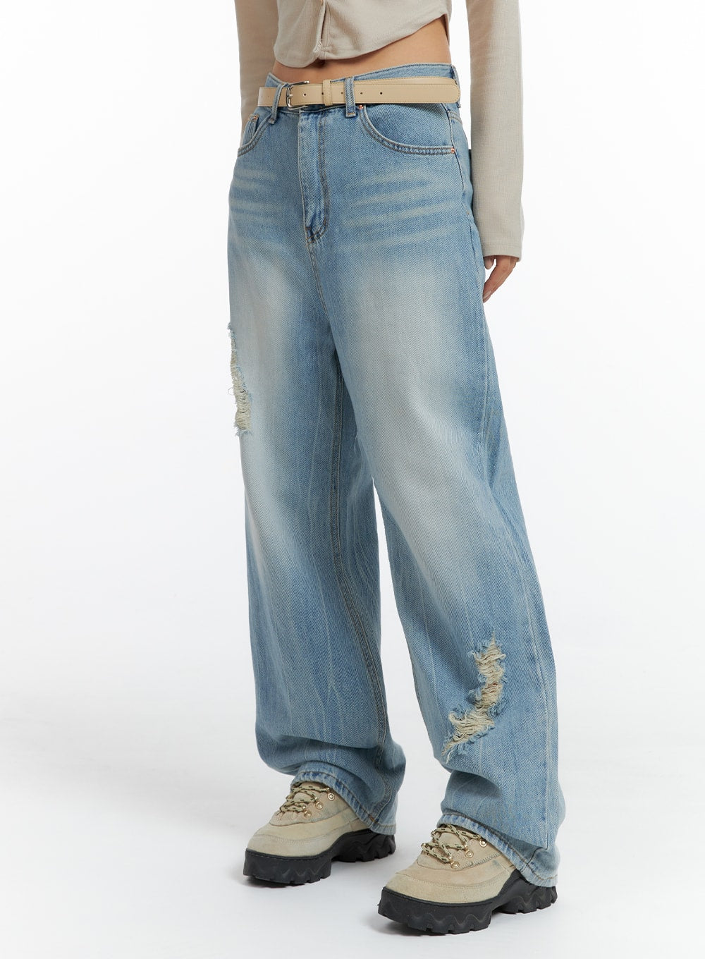 LEWKIN Distressed Wide-leg Jeans CF419 in light blue, side view on model, wide-fit washed cotton denim with destroyed rips, belted waist, paired with beige crop top and chunky sneakers.