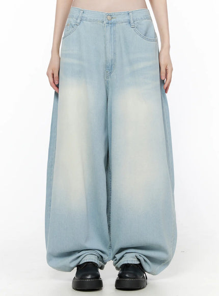 LEWKIN Ozzy Washed Wide Leg Jeans CU519 in light blue, front view on model, ultra-wide silhouette with faded wash, five-pocket styling, pooling hem over black loafers.