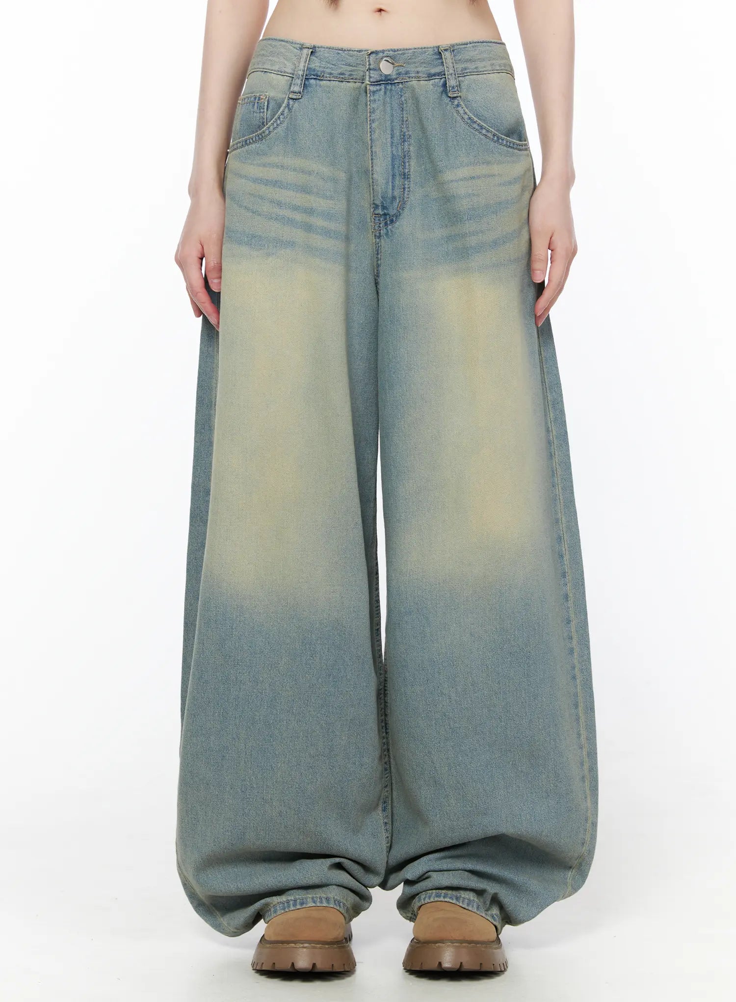 LEWKIN Rain Vintage Washed Wide Leg Jeans CU519 in light blue, front view on model, oversized wide leg silhouette with vintage wash and yellow tint fading, five-pocket design, pooling at hem.