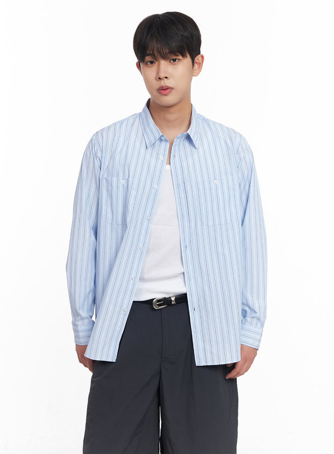 LEWKIN Men's Striped Collared Shirt IY522 in light blue, front close-up on model, oversized fit with dual chest pockets, worn open over white tee, paired with dark wide-leg shorts and belt.