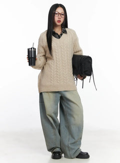 LEWKIN Lyla Washed Wide Leg Jeans CD530 in light blue, full-body front on model, oversized wide leg cotton denim with washed finish, styled with beige cable-knit sweater and black bag.