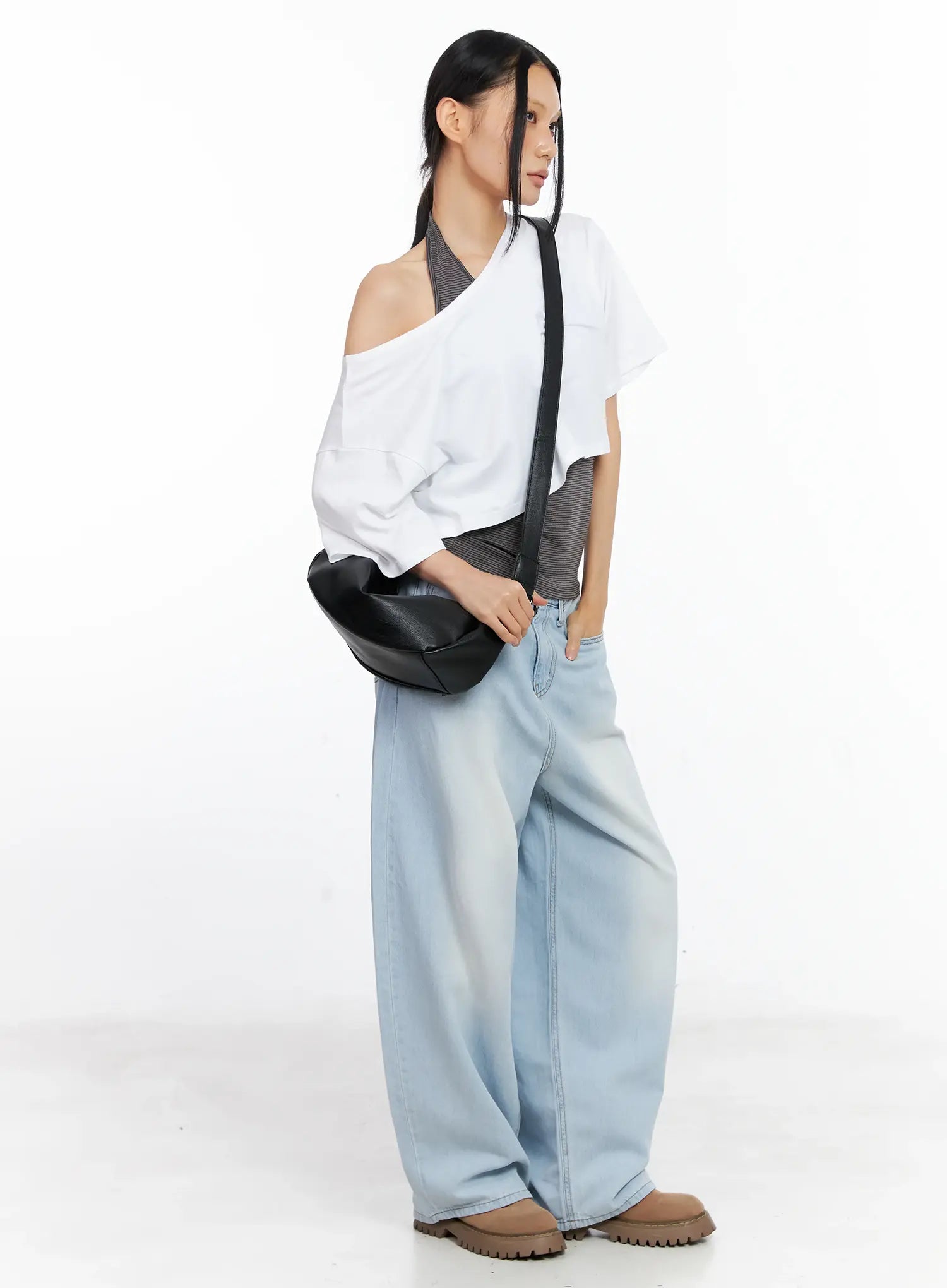 LEWKIN Bona Relaxed-Fit Denim Jeans CL529 in light blue, full-body side angle on model holding black shoulder bag, wide-leg washed cotton silhouette pooling at hem, styled with white off-shoulder top and brown chunky boots.