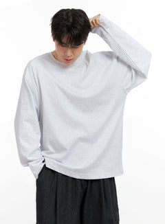 LEWKIN Men's Cozy Cotton Long Sleeve Oversize Tee IN422 in White, three-quarter front on model, hand raised to head, drop-shoulder cotton tee, paired with black wide-leg trousers.