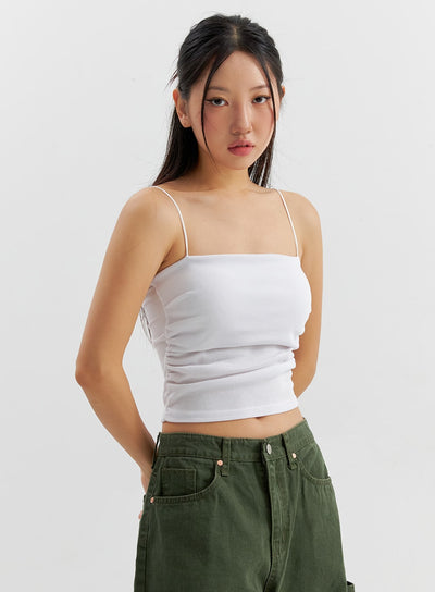 LEWKIN Ruched Camisole CO306 in white, front close-up on model, slim-fit crop square-neck cami with shirring detail and thin straps, paired with olive cargo pants.