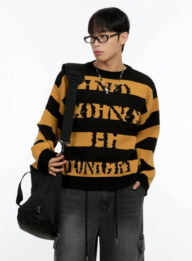 LEWKIN Men's Graphic Striped Sweater IN506 in Yellow, three-quarter front on model with crossbody bag, bold black stripe knit with distressed letter jacquard, styled with dark cargo jeans.