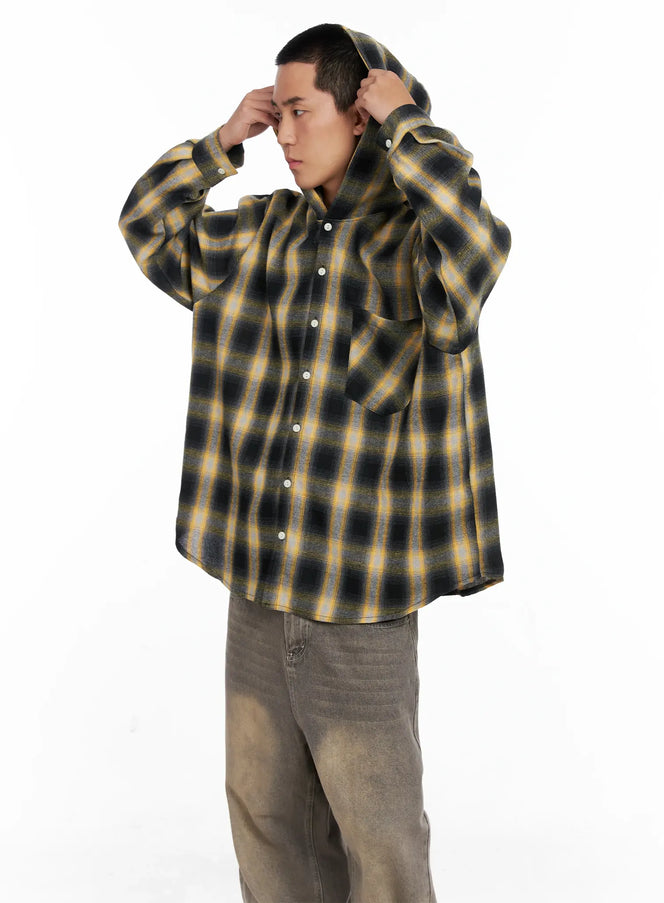 LEWKIN Men's Plaid Flannel Hooded Shirt IG529 in yellow, three-quarter view on model adjusting hood, oversized flannel with snap buttons and chest pocket, paired with grey wide-leg jeans.