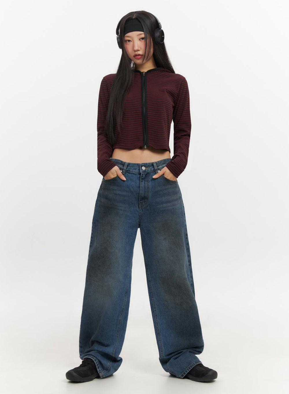 LEWKIN Brianna Dark Washed Wide-Leg Jeans IF510 in dark washed blue, full-body front on model standing straight, baggy wide-leg cotton denim, paired with red striped crop hoodie and headphones.