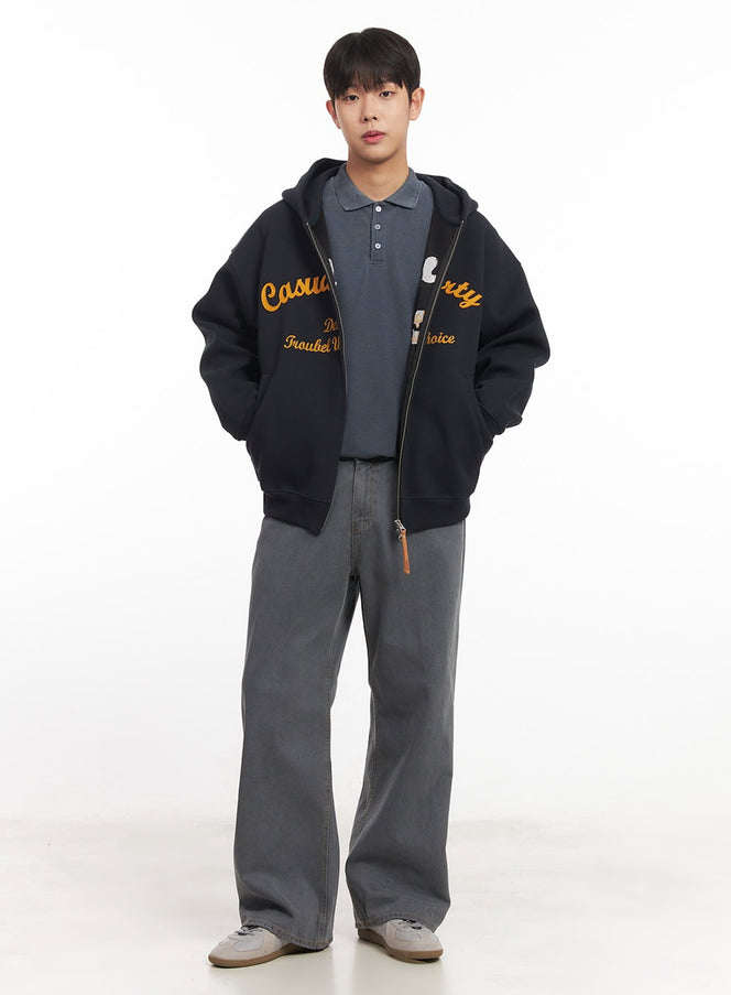 LEWKIN Men's Relaxed-Fit Jeans IM527 in grey, full-length front on model, wide-leg washed denim, styled with black graphic zip-up hoodie and polo tee.