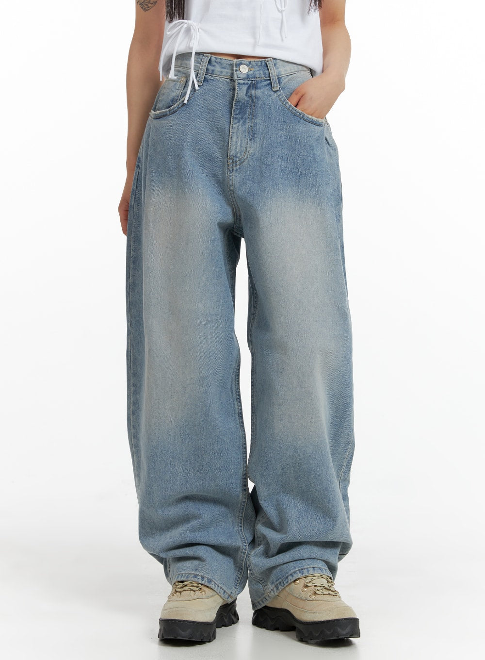 LEWKIN Wide Leg Baggy Jeans CM405 in light blue wash, front view on model, wide-fit cotton denim with pintuck detail, paired with white crop top and chunky sneakers.
