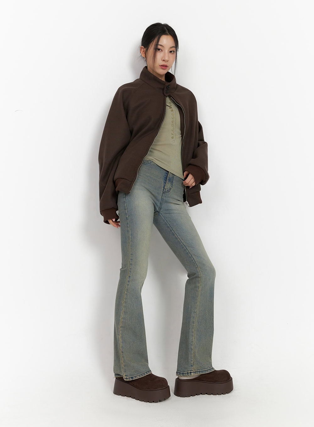 LEWKIN Cathy Washed Slim-Fit Flared Jeans IJ503 in vintage blue, three-quarter view on model, slim flare silhouette with washed denim, styled with brown bomber jacket and olive top.