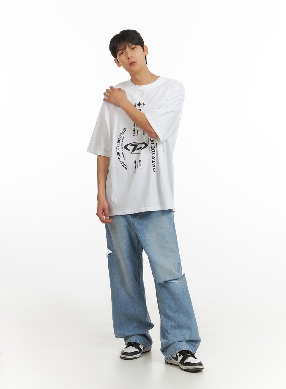 LEWKIN Men's Cut Out Baggy Jeans IU419 in blue, full-length front view on model, wide-leg washed denim with cut-out knee detail, styled with white graphic tee and sneakers.