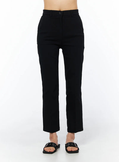 LEWKIN Hip-Pad Capri Pants CU522 in black, front view on model, high-waist tailored capri with button closure and side pockets, paired with black buckle sandals.