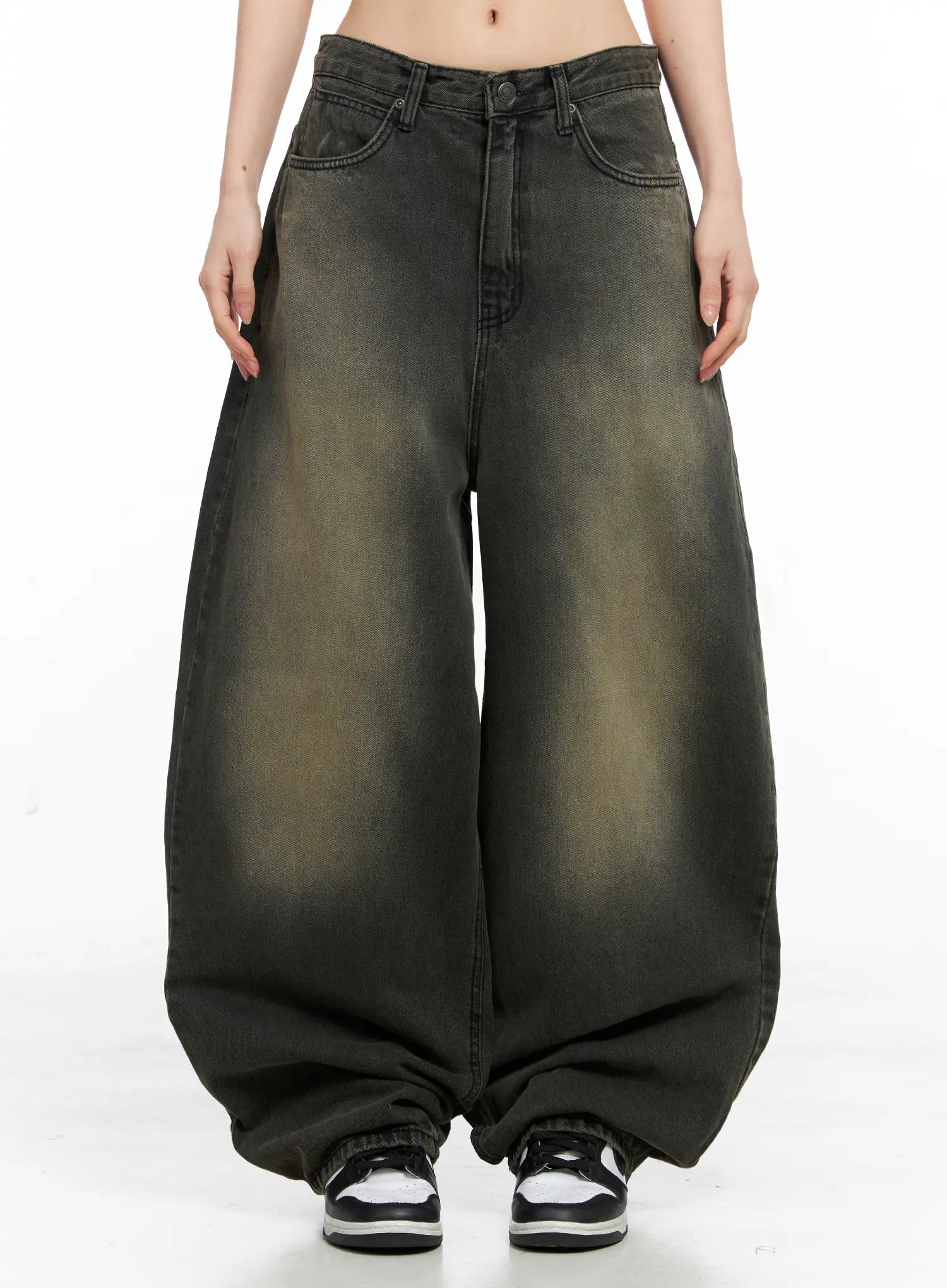 LEWKIN Elias Mega Wide Vintage Washed Jeans CC1109 in black, front view on model, ultra-wide balloon leg cotton denim with yellow-toned vintage wash, pooling at hem over sneakers.