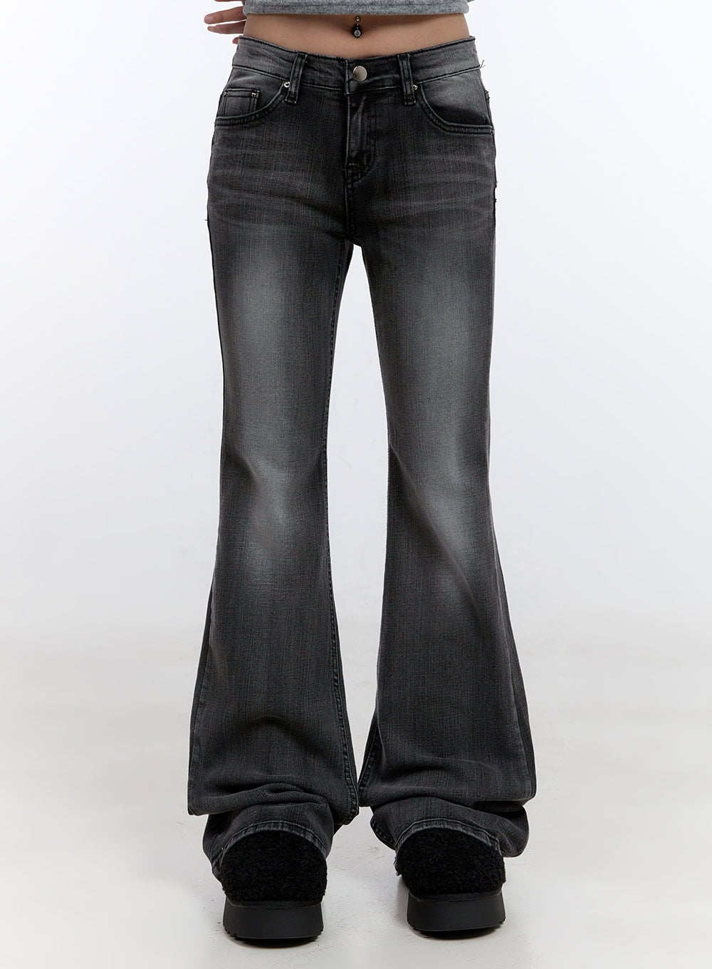 LEWKIN Gianna Faded Flared Jeans CO422 in Black, front crop shot on model, slim-fit low-rise washed denim with flared hem, worn with black platform shoes.