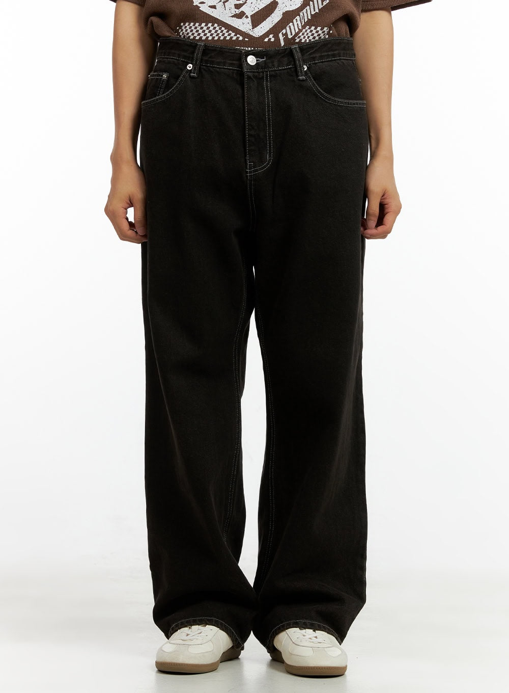LEWKIN Men's Wide Fit Washed Baggy Jeans CL429 in Black, front waist-to-hem crop on model, wide-leg washed denim with contrast stitching, paired with brown graphic tee and white sneakers.