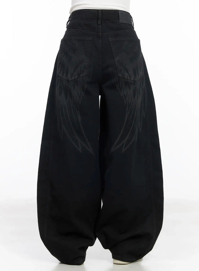 LEWKIN Angel Wing Wide-Leg Trousers CM526 in black, back view on model, balloon-fit cotton trousers with tone-on-tone angel wing graphic print across rear panels and back pockets.
