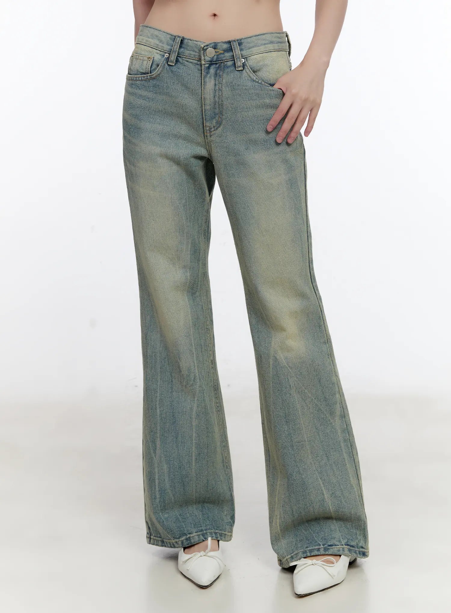 LEWKIN Roa Vintage Blue Flared Denim Jeans CL504 in blue, front waist-to-hem shot on model, low-rise bootcut with washed yellow-tinted denim, front pockets, paired with white bow flats.