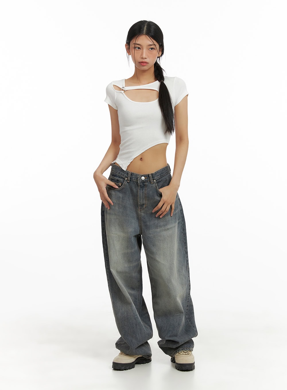 LEWKIN Vintage Washed Baggy Jeans CA424 in blue, full-body front view on model, wide-fit cotton denim with vintage wash, pooling hem, styled with white asymmetric crop top and chunky sneakers.