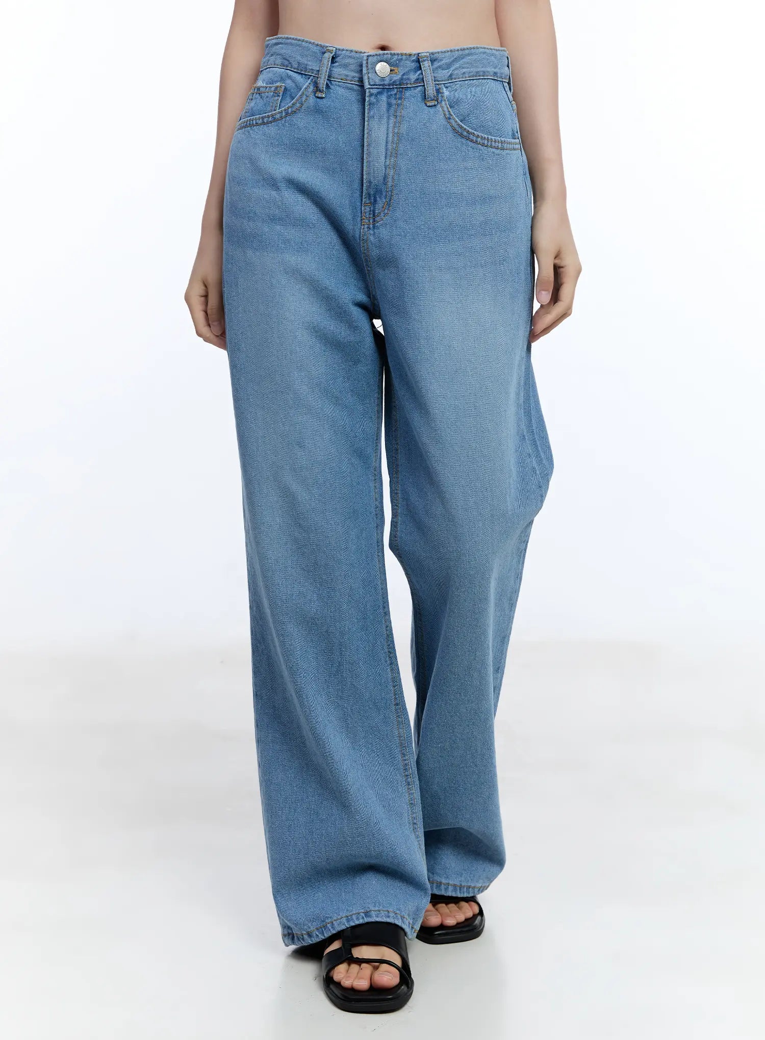 LEWKIN Jisoo Straight-Fit Jeans CU513 in blue, front waist-down shot on model, wide-fit washed cotton denim with 5-pocket styling, paired with black sandals.