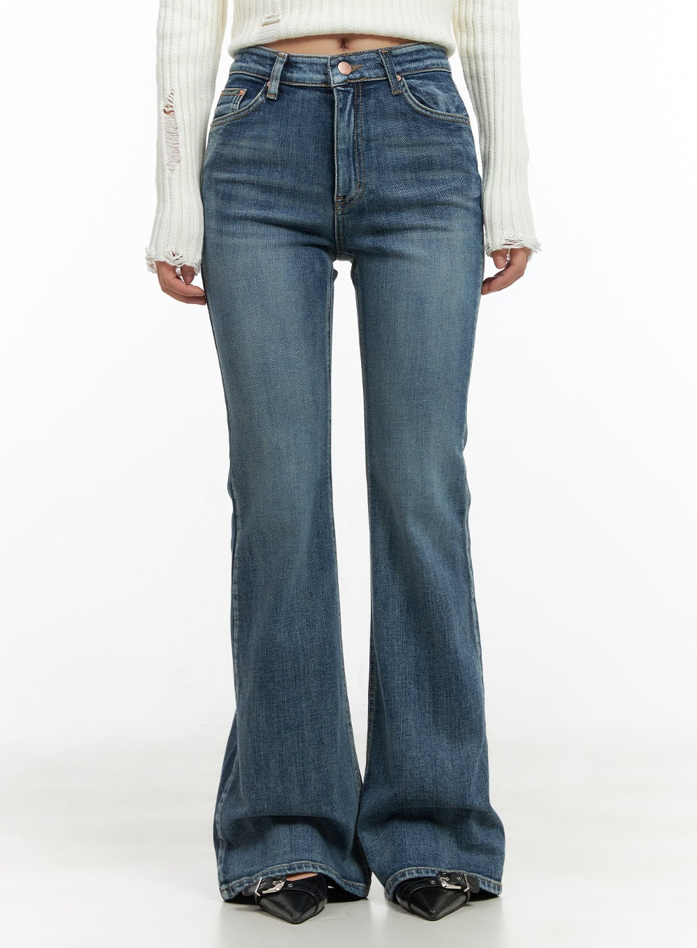 LEWKIN Lila Slim Bootcut Jeans CG422 in blue, front close-up on model, washed denim slim fit with bootcut flare hem, high-rise waist, paired with white ribbed knit and black buckle boots.