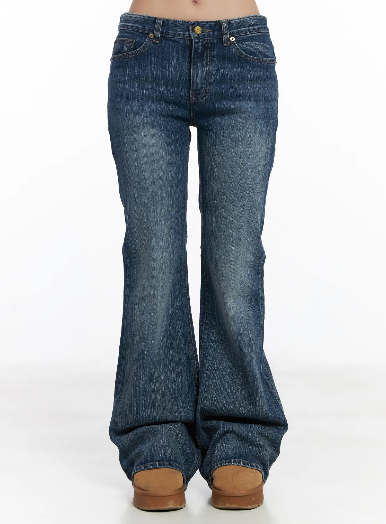 LEWKIN Astrid Low Rise Flared Bootcut Jeans CJ514 in blue, front view on model (waist-to-hem), wide flared leg with washed cotton denim, gold button, paired with tan platform shoes.