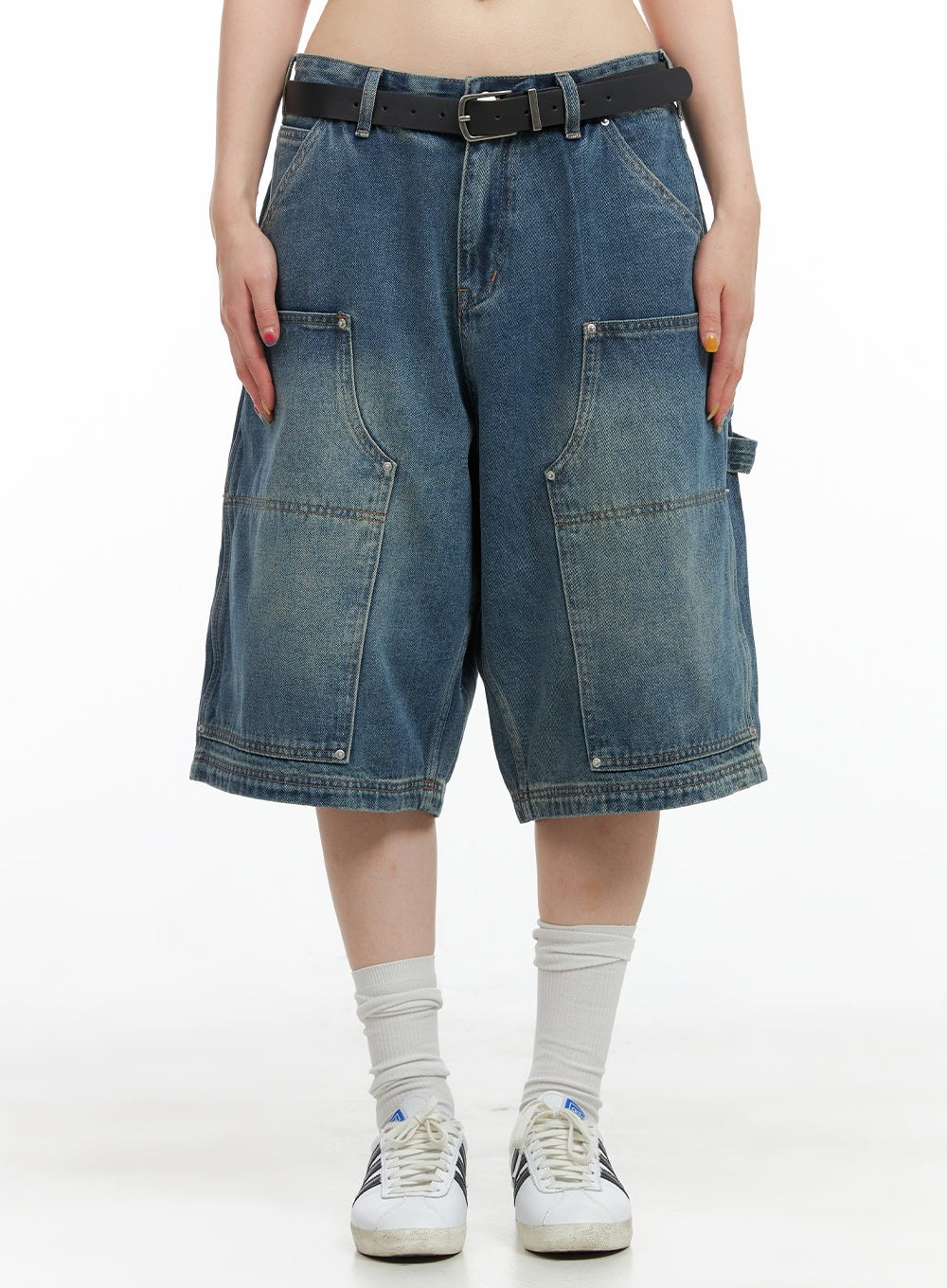 LEWKIN Stud Washed Baggy Jorts (UNISEX) CG408 in blue, front crop view on model, wide-fit washed denim with large carpenter pockets, stud details, paired with black belt and sneakers.