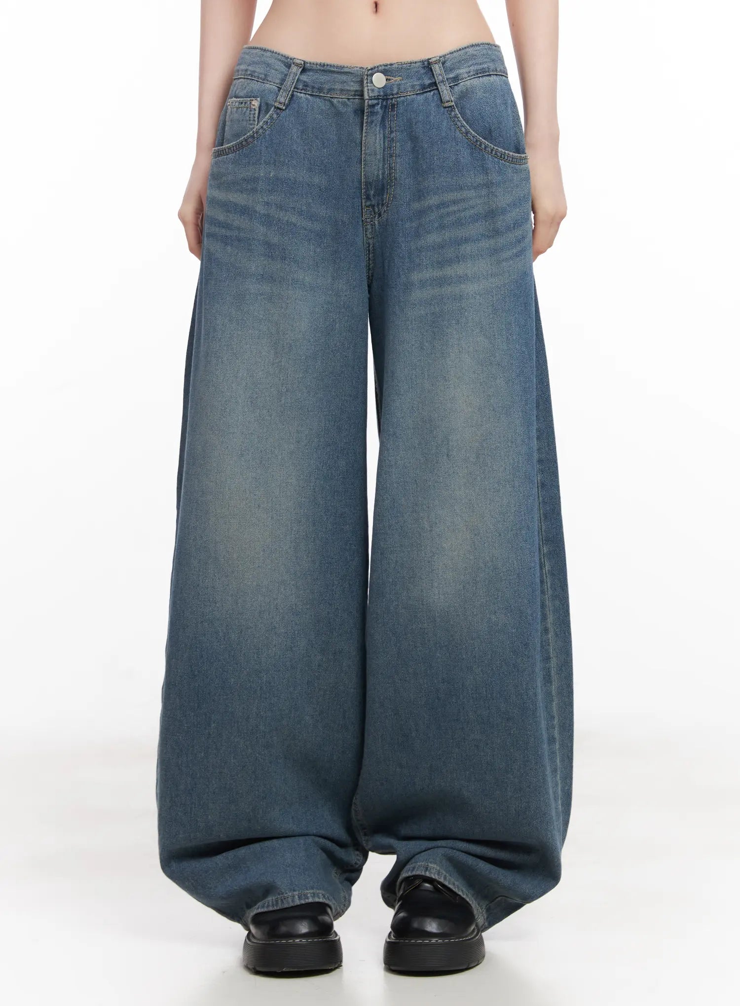 LEWKIN Chaewon Washed Wide-Leg Jeans CU511 in blue, front crop view on model, low-rise baggy fit, washed cotton denim with faded whisker detail, paired with black loafers.