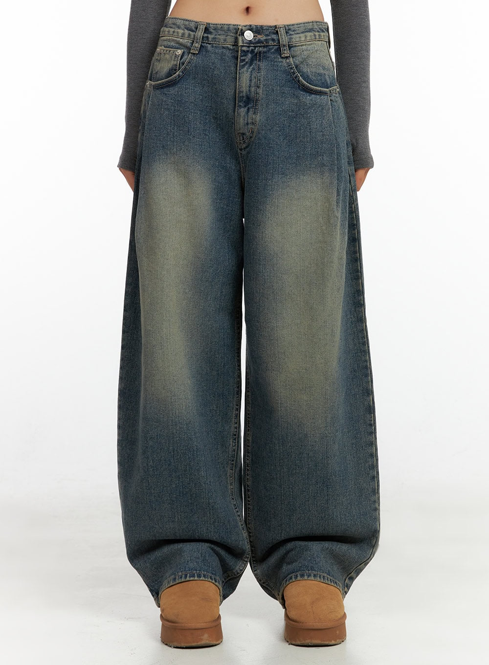 LEWKIN Peyton Pin-Tuck Washed Baggy Jeans CO424 in blue, front crop view on model, wide-fit washed cotton denim with pintuck pleats and faded yellow toning, paired with tan platform boots.