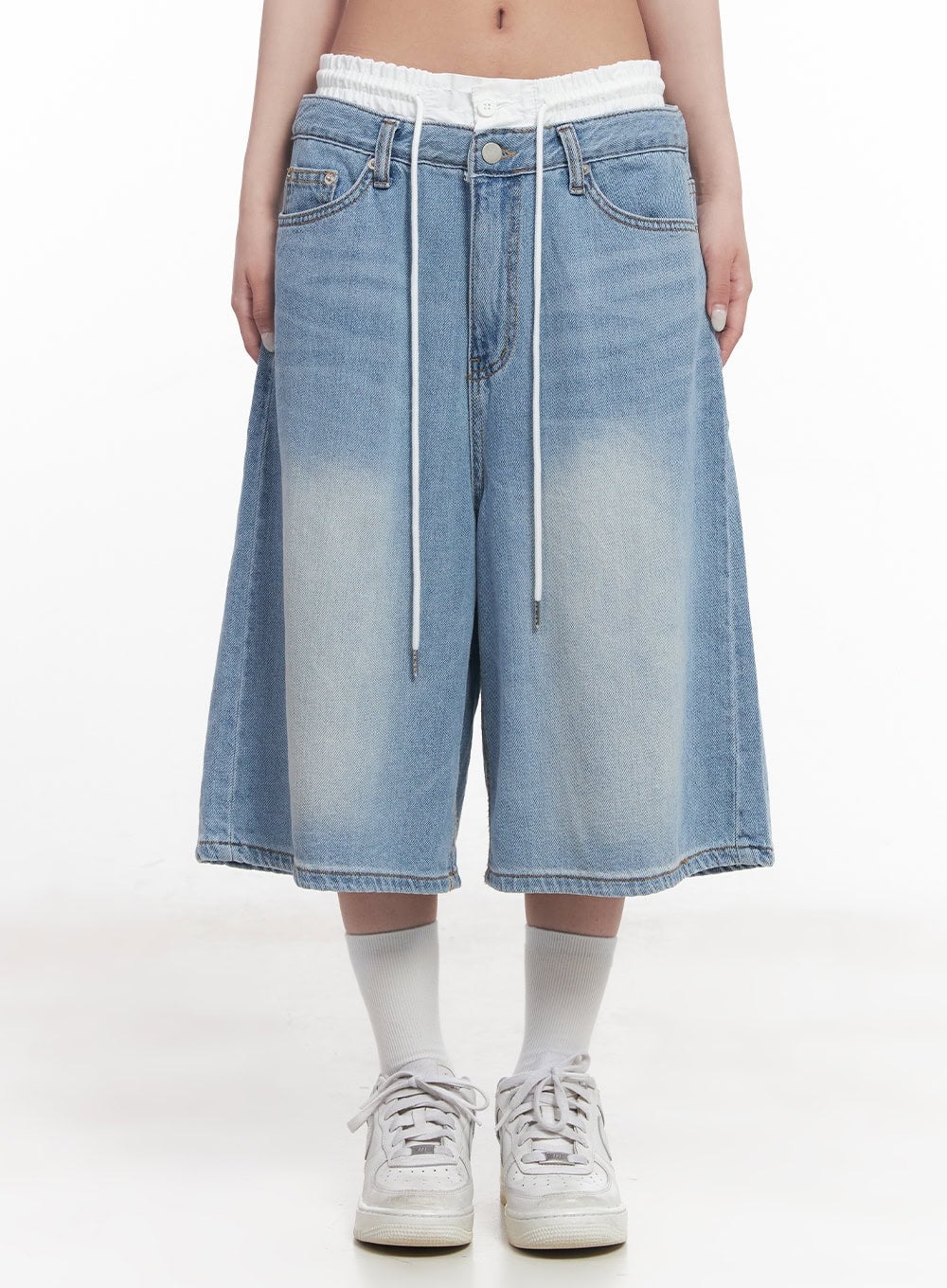 LEWKIN Layered Drawstring Baggy Jorts CY527 in light blue, front view on model, low-waist washed denim with white elasticated inner layer and dangling drawstring, wide midi length, styled with white socks and sneakers.