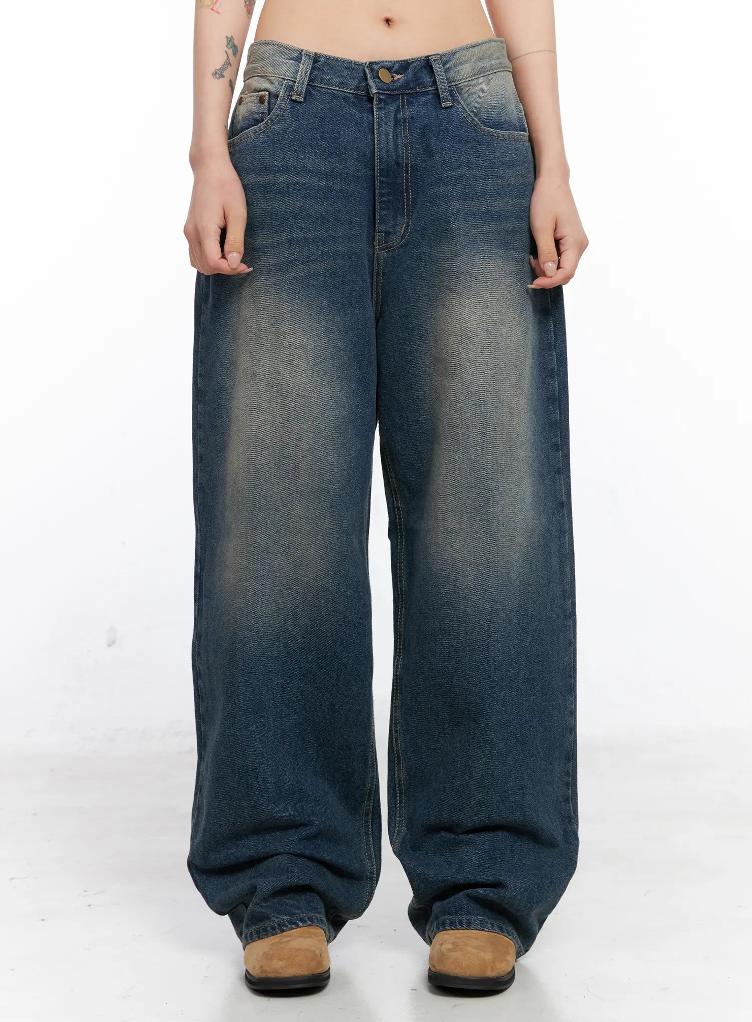 LEWKIN Xyla Vintage Pocket Baggy Jeans CO507 in blue, front view on model, loose-fit washed cotton denim with faded whisker details, paired with tan boots.