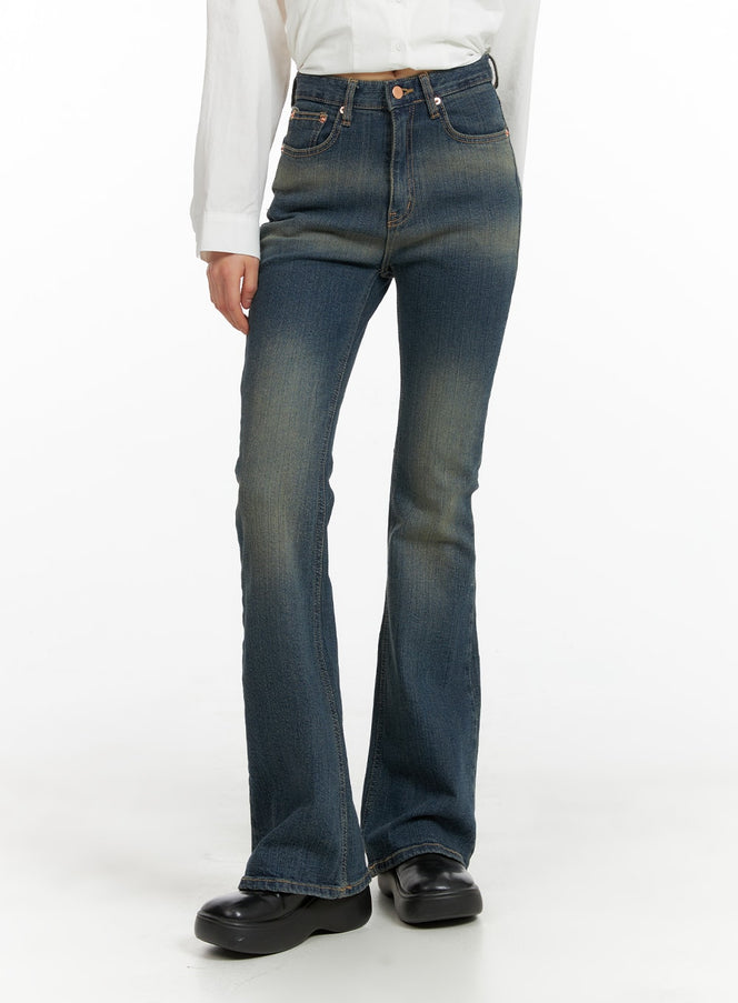 LEWKIN Washed Flared Jeans CM413 in blue, front three-quarter crop view on model, slim-fit high-rise denim with vintage wash, paired with white shirt and black loafers.