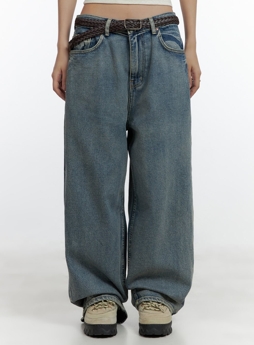 LEWKIN Dark Washed Baggy Jeans CL410 in blue, front waist close-up on model, low-rise wide-fit cotton denim with washed finish, styled with a brown braided belt and chunky sneakers.