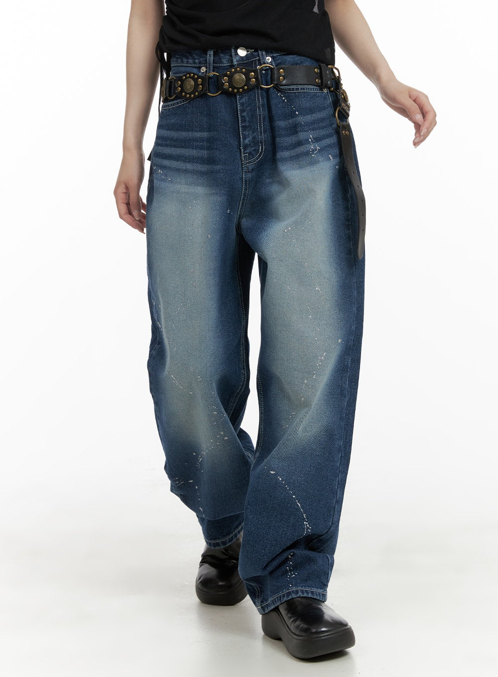 LEWKIN Splash Paint Baggy Jeans CA408 in blue, front waist-to-hem crop on model, wide-fit washed denim with white paint splatter, styled with studded leather belt and black platform shoes.
