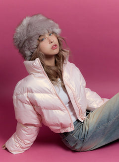 LEWKIN SnugFit Puffer Coat CN425 in pink, close-up on seated model with fur hat, glossy nylon crop silhouette, zip-up front, paired with wide-leg jeans.
