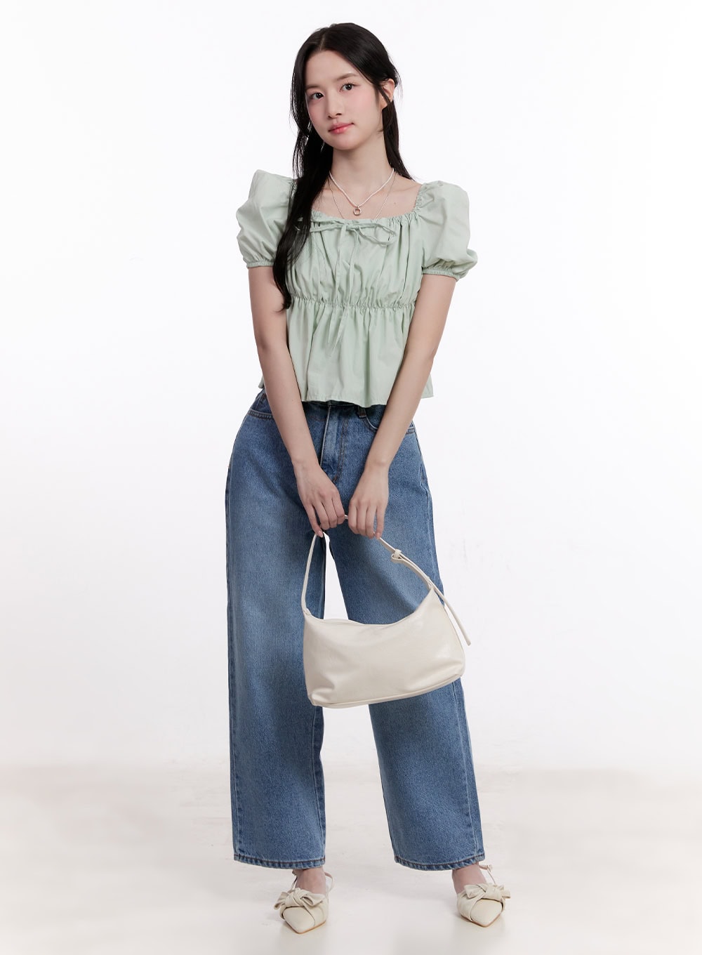 LEWKIN Jamie Comfy Straight-Fit Jeans CM526 in mid-blue wash, full-body front view on model, straight-leg cotton denim, paired with mint puff-sleeve top and cream shoulder bag.