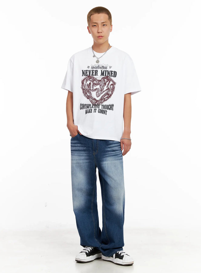 LEWKIN Men's Steel Chain Necklace IL518 in silver, full-body front shot on male model, layered over white graphic tee and blue wide-leg jeans, coin pendant visible at neckline.