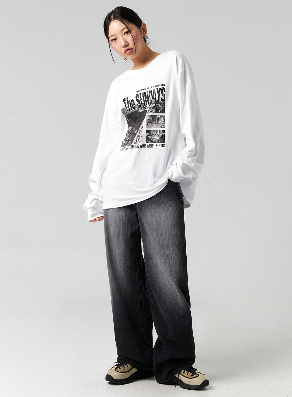 LEWKIN Washed Wide-Leg Jeans CG327 in black, full-body angled shot on model, relaxed wide-leg cotton denim with faded wash, paired with oversized graphic long-sleeve tee and chunky sneakers.