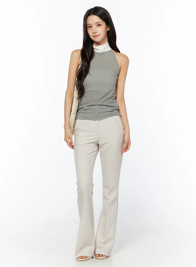 LEWKIN High-Waist Stretch Flared Slacks CU522 in light beige, front full-body on model, smooth stretch fabric, flared leg silhouette, paired with sage halter top and cream shoulder bag.