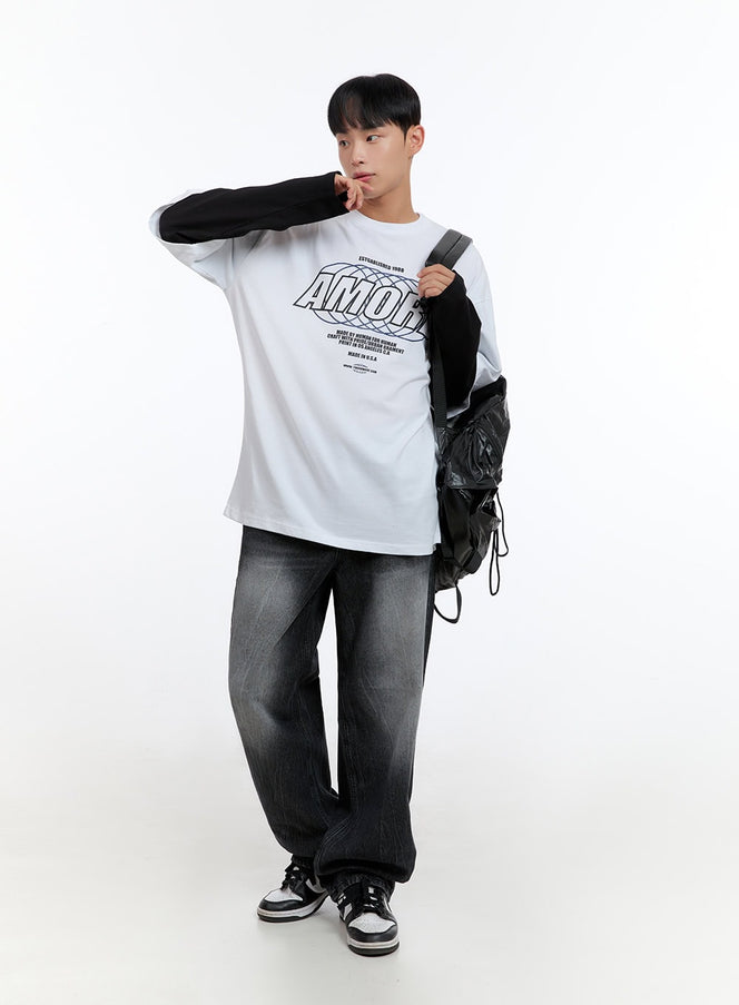 LEWKIN Men's Washed Black Denim Wide Jeans IS413 in washed black, three-quarter view on model with relaxed pose, wide-leg silhouette, paired with graphic tee and black backpack.