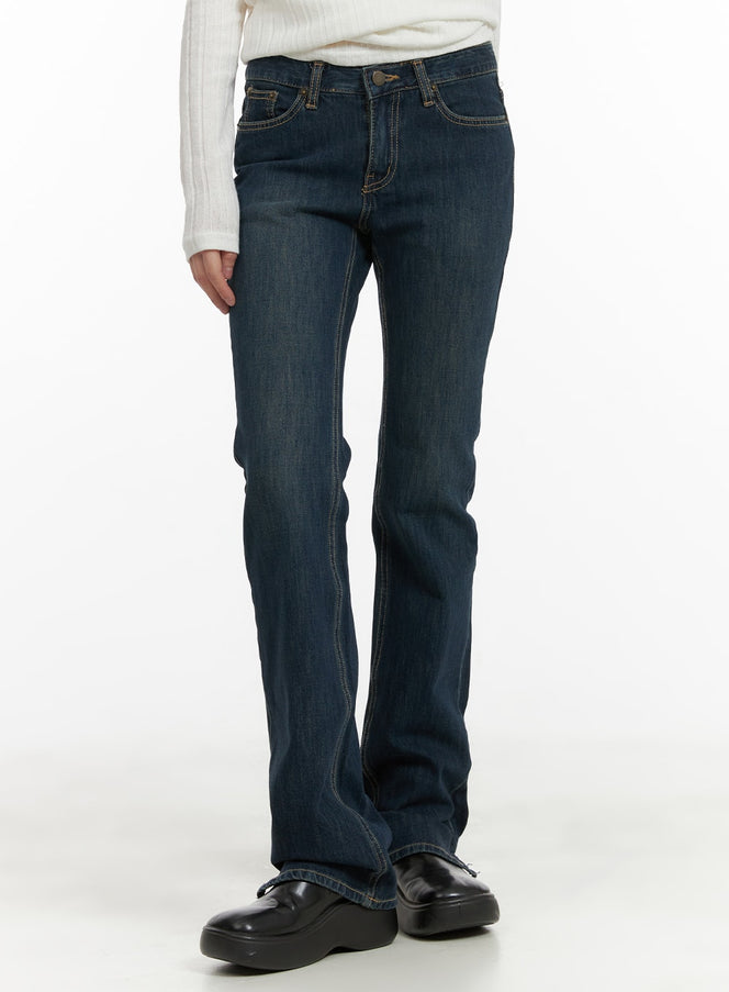 LEWKIN Slim Fit Bootcut Jeans CA418 in dark blue, front three-quarter crop on model, slim thigh with subtle bootcut flare, washed denim, paired with white ribbed top and black loafers.