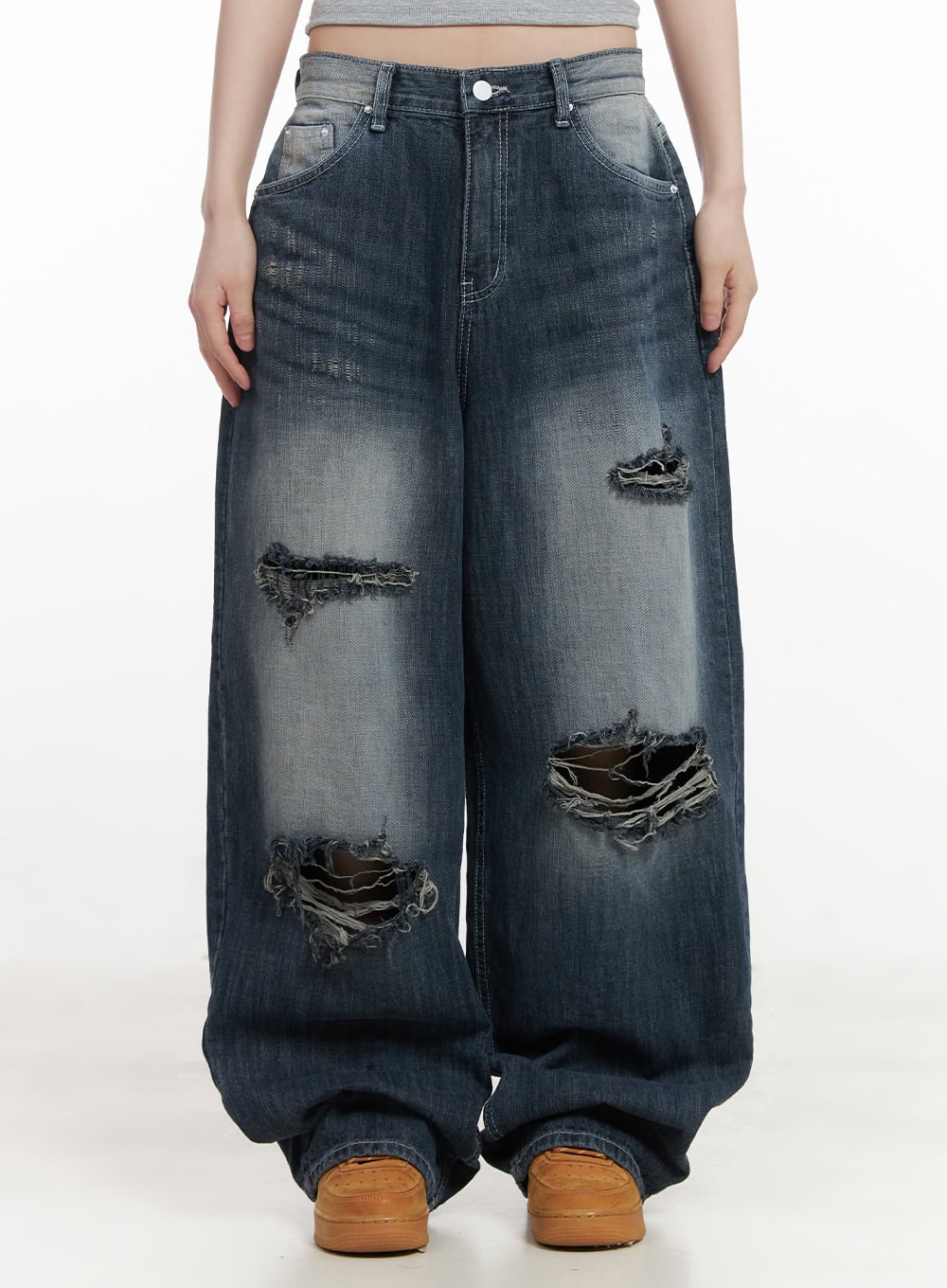 LEWKIN Alison Destroyed Baggy Jeans CJ523 in dark blue, front product shot on model, wide-fit washed denim with heavy frayed rip details, pooling hem, paired with tan sneakers.