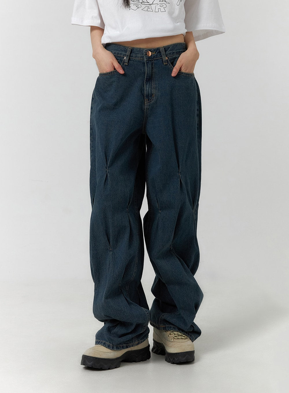 LEWKIN Quilted Wide Leg Denim CF406 in dark blue, front cropped view on model, wide-fit washed cotton denim with diamond quilting pintuck detail, paired with white graphic tee and chunky sneakers.